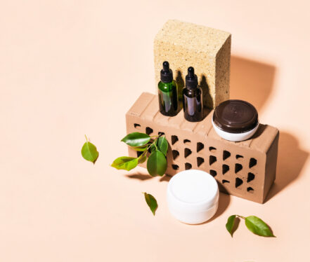 Isometric view of trendy composition made of bricks and Natural cosmetic products in earthy colors.